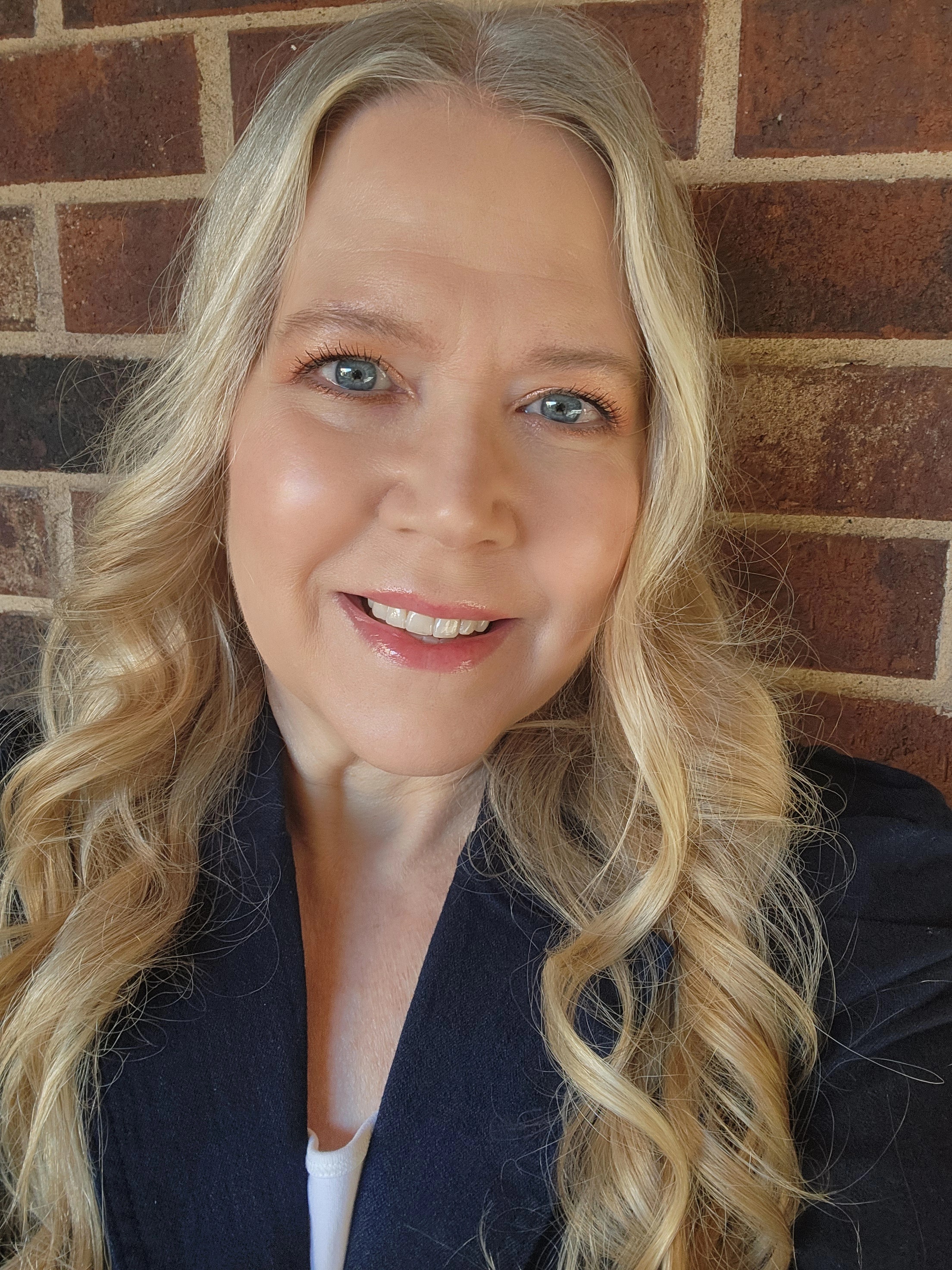 A headshot of a blonde woman